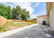 A fenced backyard featuring a concrete slab, grassy area, and access to the house at 1009 S Ivey Ln, Orlando, FL 32811