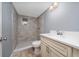 Bathroom featuring a tile shower, white vanity, and modern fixtures at 1009 S Ivey Ln, Orlando, FL 32811