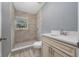 Updated bathroom featuring a walk-in shower and new vanity at 1009 S Ivey Ln, Orlando, FL 32811