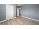 A spacious bedroom with wood-look floors, a closet, and light blue painted walls at 1009 S Ivey Ln, Orlando, FL 32811