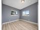 A bedroom with wood-look floors and two windows providing natural light at 1009 S Ivey Ln, Orlando, FL 32811