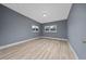 A bedroom with wood-look floors and two windows providing natural light at 1009 S Ivey Ln, Orlando, FL 32811
