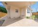 Beige home featuring a covered carport with a concrete floor at 1009 S Ivey Ln, Orlando, FL 32811