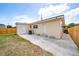 Rear exterior of the home showing the fenced yard, air conditioning unit, and back entrances at 1009 S Ivey Ln, Orlando, FL 32811