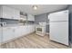 Kitchen with white cabinets, stainless steel sink, and modern appliances at 1009 S Ivey Ln, Orlando, FL 32811