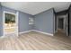 Bright living room with wood floors and an open doorway at 1009 S Ivey Ln, Orlando, FL 32811