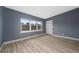 Living room with gray walls, light wood floors, and natural light at 1009 S Ivey Ln, Orlando, FL 32811