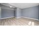 Bright living room featuring wood floors and a modern light fixture at 1009 S Ivey Ln, Orlando, FL 32811