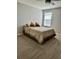 Neutral bedroom features a comfortable bed with neutral bedding, a ceiling fan and a window at 1016 Cascade Dr, Davenport, FL 33837
