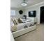 This bedroom features neutral tones, a modern light fixture, and ample natural light from the window at 1016 Cascade Dr, Davenport, FL 33837
