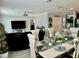 Elegant dining room with modern decor and an open view into a comfortable living space at 1016 Cascade Dr, Davenport, FL 33837