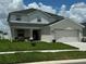 Charming two-story home with a manicured lawn and inviting curb appeal at 1016 Cascade Dr, Davenport, FL 33837