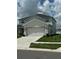 Two-story home with a two-car garage and well-kept lawn at 1016 Cascade Dr, Davenport, FL 33837
