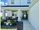 Inviting front porch features comfortable seating and a beautifully landscaped garden at 1016 Cascade Dr, Davenport, FL 33837