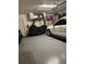 Garage featuring epoxy floors, a white vehicle and a covered motorcycle at 1016 Cascade Dr, Davenport, FL 33837