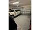 Spacious garage with ample space for parking and storage, including epoxy flooring at 1016 Cascade Dr, Davenport, FL 33837