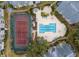 Aerial view of the pool, tennis courts, and the building with its manicured landscaping and beautiful grounds at 1023 S Hiawassee Rd # 4017, Orlando, FL 32835