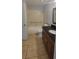 Tiled bathroom featuring a shower with grab bars and dark vanity with a mirror at 1023 S Hiawassee Rd # 4017, Orlando, FL 32835