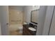 Bathroom with shower with grab bars, and dark vanity with a large mirror at 1023 S Hiawassee Rd # 4017, Orlando, FL 32835
