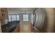 Kitchen leading to a bright living area features stainless steel appliances and dark countertops, perfect for cooking and entertaining at 1023 S Hiawassee Rd # 4017, Orlando, FL 32835