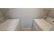 Bright laundry room with washer, dryer, and convenient overhead shelving for ample storage at 1023 S Hiawassee Rd # 4017, Orlando, FL 32835