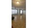 Bright living room featuring tile flooring, neutral paint, and ample natural light from large windows at 1023 S Hiawassee Rd # 4017, Orlando, FL 32835