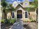 Exterior shot of the mailboxes at this yellow two-story condo building with white trim and tropical plants at 1023 S Hiawassee Rd # 4017, Orlando, FL 32835