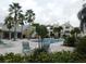 A beautiful community pool with tables, chairs, and lounge chairs for residents to enjoy in this tropical paradise at 1023 S Hiawassee Rd # 4017, Orlando, FL 32835