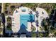 Aerial view of a rectangular pool surrounded by an abundance of lounge chairs and tropical landscaping at 1023 S Hiawassee Rd # 4017, Orlando, FL 32835