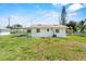 Rear exterior of a simple home with a covered area and grassy backyard at 120 & 0 8Th Wahneta W St, Winter Haven, FL 33880