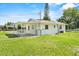 Rear exterior of home with covered area and grassy backyard at 120 & 0 8Th Wahneta W St, Winter Haven, FL 33880