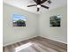Neutral bedroom featuring two windows, ceiling fan and light vinyl floors at 120 & 0 8Th Wahneta W St, Winter Haven, FL 33880