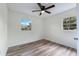 Bright bedroom with two windows, ceiling fan and neutral walls with modern vinyl flooring at 120 & 0 8Th Wahneta W St, Winter Haven, FL 33880