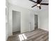 A bedroom with neutral walls, a ceiling fan and an open closet space at 120 & 0 8Th Wahneta W St, Winter Haven, FL 33880