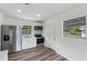 An open kitchen area featuring stainless steel appliances, white cabinets, and wood-look flooring at 120 & 0 8Th Wahneta W St, Winter Haven, FL 33880