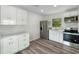 Modern kitchen with stainless steel appliances, white cabinetry, and stylish flooring at 120 & 0 8Th Wahneta W St, Winter Haven, FL 33880