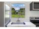 Bright kitchen featuring a modern stainless steel sink, faucet and a view of the backyard at 120 & 0 8Th Wahneta W St, Winter Haven, FL 33880