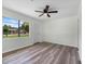 Bright living room with modern flooring, ceiling fan, and large window at 120 & 0 8Th Wahneta W St, Winter Haven, FL 33880