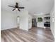 Open-concept living space featuring modern floors and a glimpse of the kitchen with stainless appliances at 120 & 0 8Th Wahneta W St, Winter Haven, FL 33880