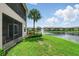 View of backyard overlooking water and landscaped grounds at 1225 Bella Cara Ct # 1, Davenport, FL 33896