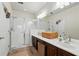 Bathroom features a large vanity with double sinks and walk-in shower with glass door at 1225 Bella Cara Ct # 1, Davenport, FL 33896