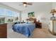 Cozy bedroom featuring a large window, ceiling fan, and an inviting blue comforter at 1225 Bella Cara Ct # 1, Davenport, FL 33896
