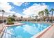 Resort-style swimming pool with ample lounge chairs and shaded umbrellas at 1225 Bella Cara Ct # 1, Davenport, FL 33896