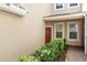 Exterior entrance showcasing well-maintained landscaping, a covered porch, and brick walkway at 1225 Bella Cara Ct # 1, Davenport, FL 33896