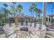 Community outdoor fireplace with white Adirondack chairs at 1225 Bella Cara Ct # 1, Davenport, FL 33896