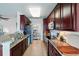 A well-lit kitchen with granite countertops and stainless steel appliances, with sightlines to the dining room and living room at 1225 Bella Cara Ct # 1, Davenport, FL 33896