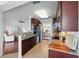 Well-lit kitchen with granite countertops, stainless steel appliances, and sightlines to living room at 1225 Bella Cara Ct # 1, Davenport, FL 33896