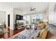 The living room has hardwood floors, comfortable seating, and a slider to the deck at 1225 Bella Cara Ct # 1, Davenport, FL 33896
