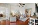 Bright living room with hardwood floors, comfortable seating, ceiling fan, and nautical-themed artwork at 1225 Bella Cara Ct # 1, Davenport, FL 33896