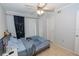 Bedroom with light wood floors and a ceiling fan, closet, and sliding glass doors leading to the outside at 139 Oyster Bay Cir # 200, Altamonte Springs, FL 32701